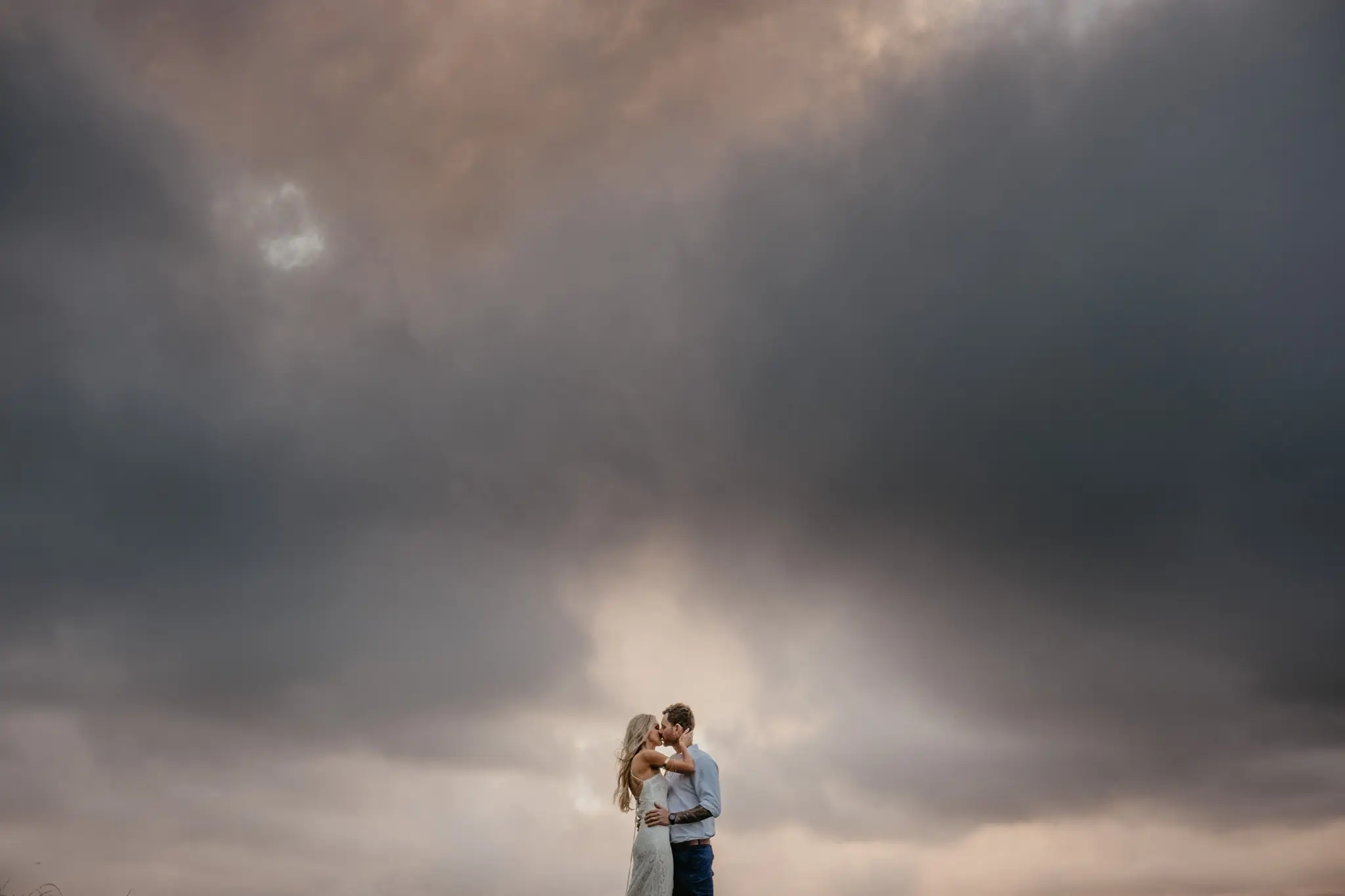 A couple standing together in wild coastal country