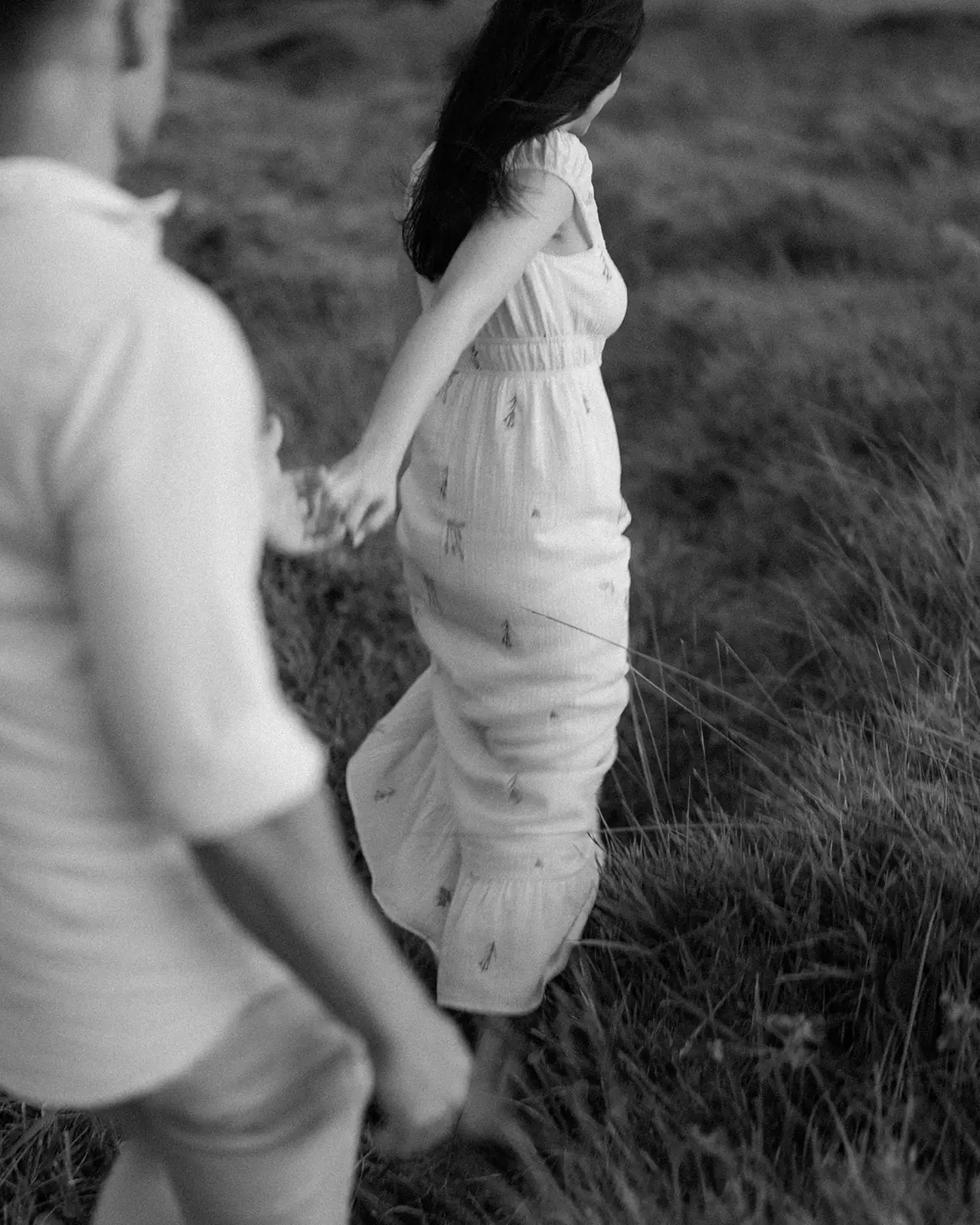 Brent lifting Mel off her feet in the grass, Lord Howe Island