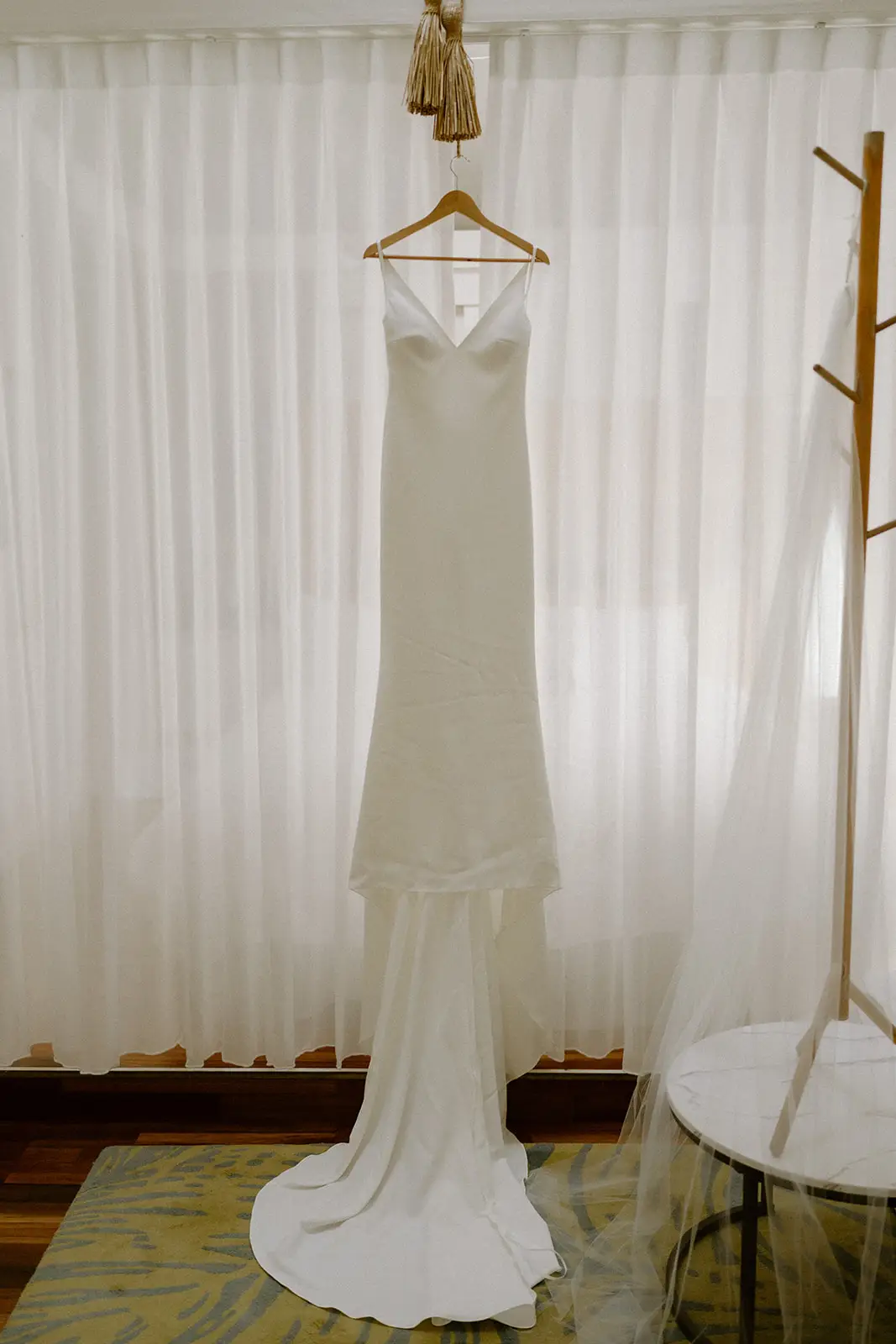 Mel's wedding dress hanging against white curtains, Lord Howe Island
